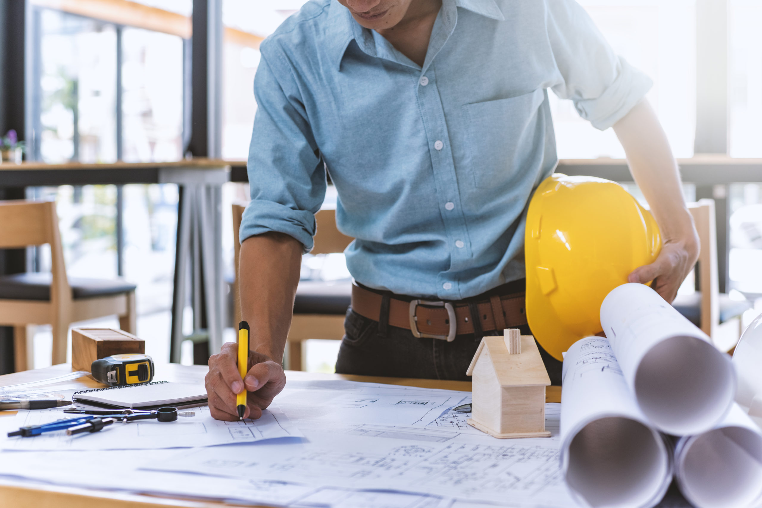 A contractor looks at a set of blueprints